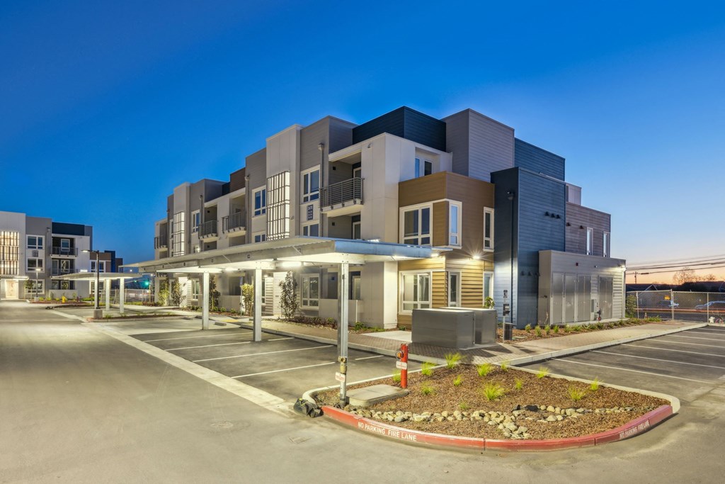 a building with a parking lot in front of it at night at 38° NORTH, Santa Rosa