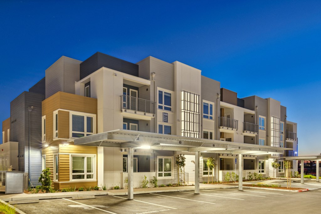 a modern apartment building with a parking lot at night at 38° NORTH, Santa Rosa, CA 95404