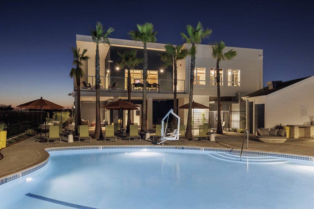 a large swimming pool in front of a hotel at night at 38° NORTH, Santa Rosa, 95404