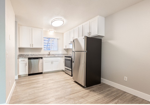 Kitchen with stainless steel appliances and dining area