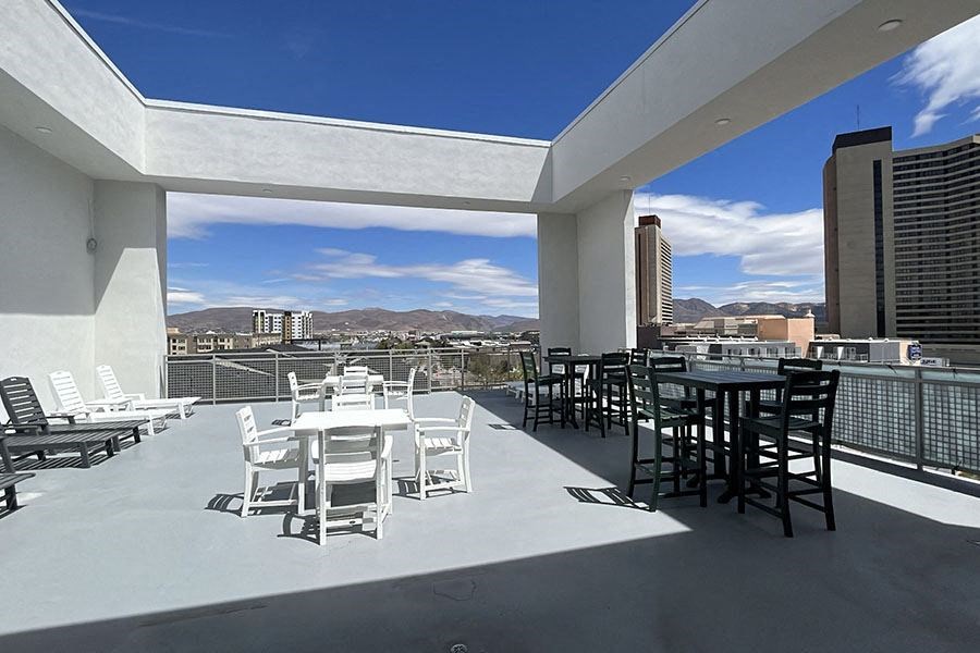 Apartments For Rent In Sparks, NV - Rooftop Lounge With Lounge Chairs, Tables, Chairs, And Views Of The Downtown Area.