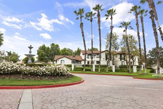 a driveway with a fountain in the middle of it
