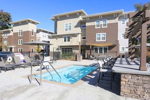 Apartments for Rent Chico - Cedar Flats - Pool with Lounge Chairs and Umbrellas and Concrete Island with Barstools