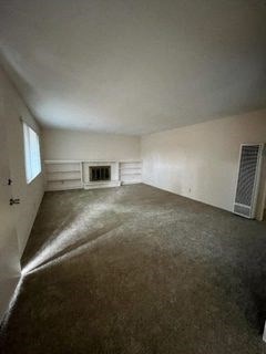 an empty room with a window and a door