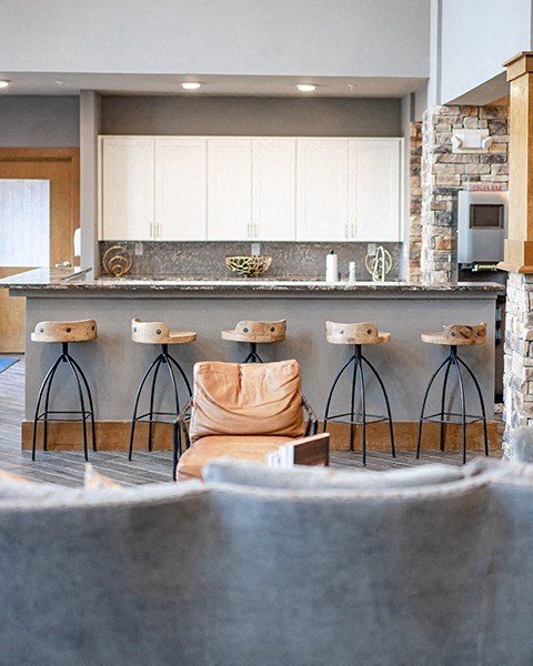 a kitchen with bar stools and a counter top