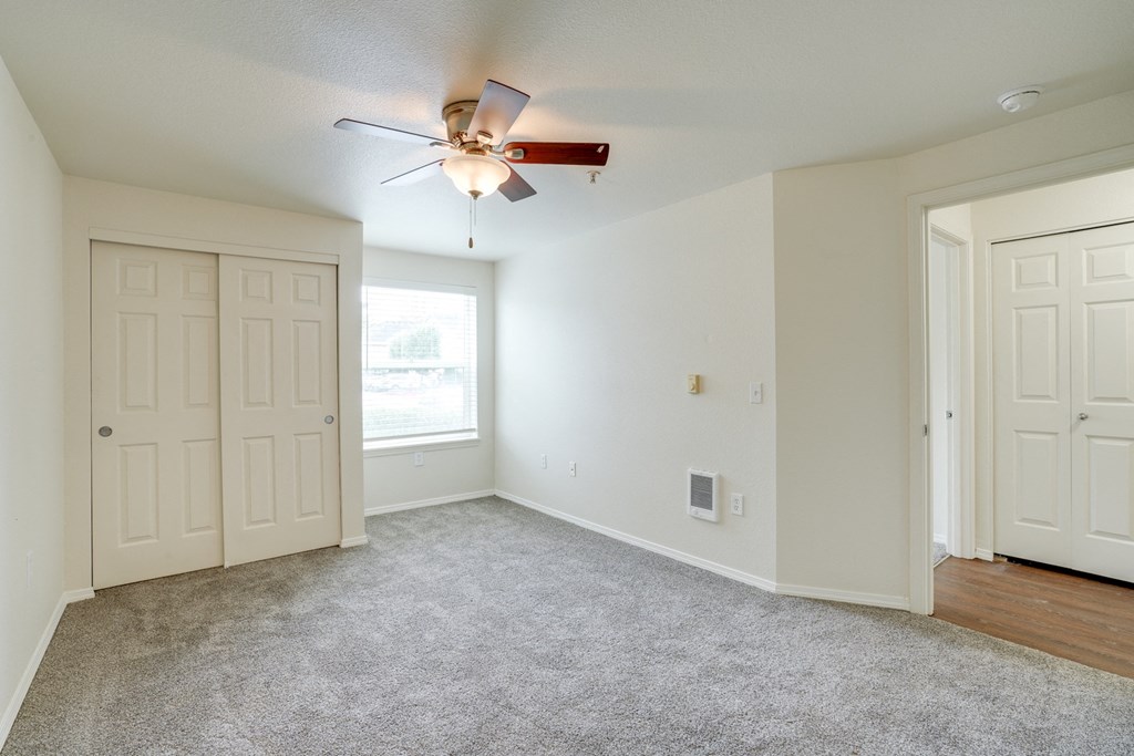 Unfurnished room with ceiling fan and light1 at THE VILLAGE Apartments, KEIZER, OR