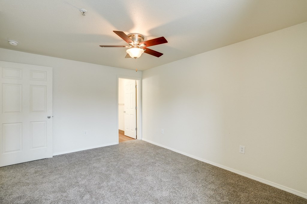 Unfurnished room with ceiling fan and light at THE VILLAGE Apartments, KEIZER, Oregon