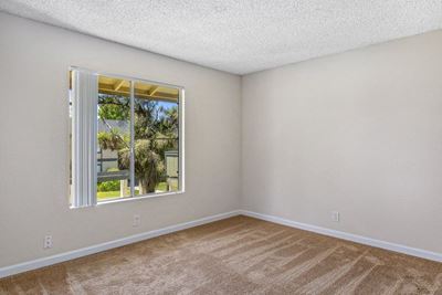 Bedroom with window l Crestview Pines Apartments