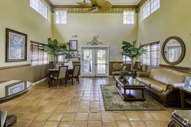 a large living room with a leather couch and a coffee table