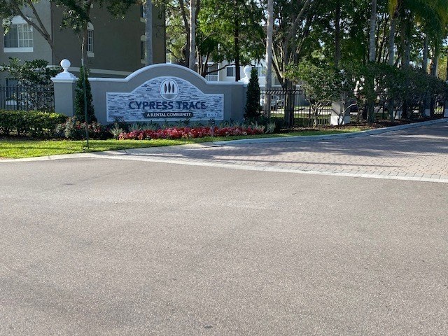 a driveway in front of a building with a sign that says cypress place