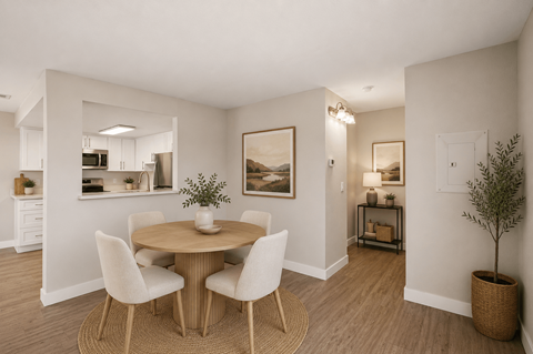 Dining area with round table and upholstered chairs at Dash Apartments, Nevada