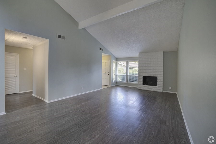 an empty living room with a fireplace