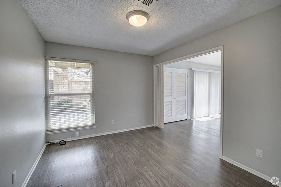 an empty living room with a large window