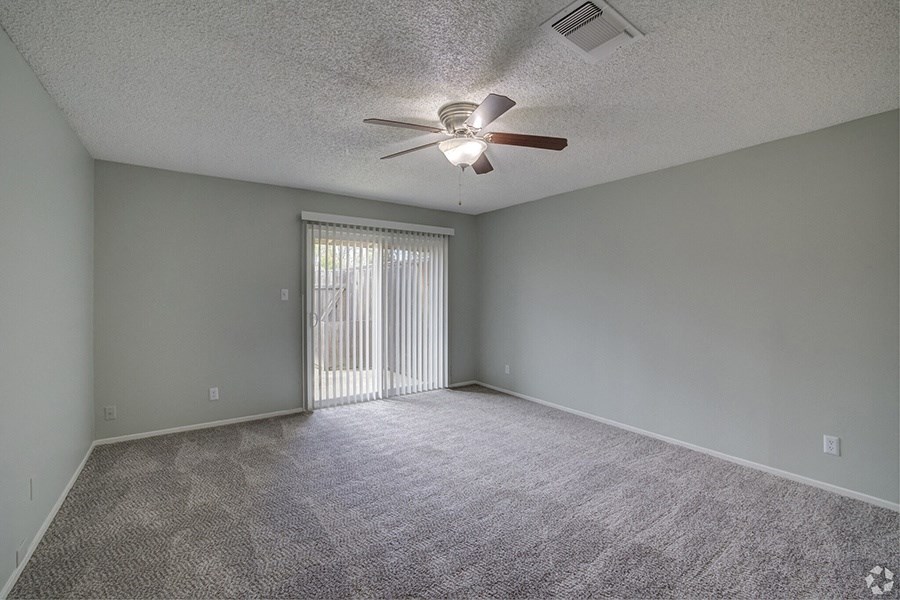 the spacious living room with a patio door