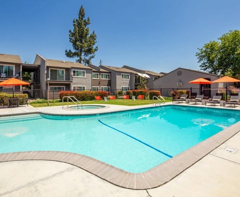 A swimming pool in front of a residential area.