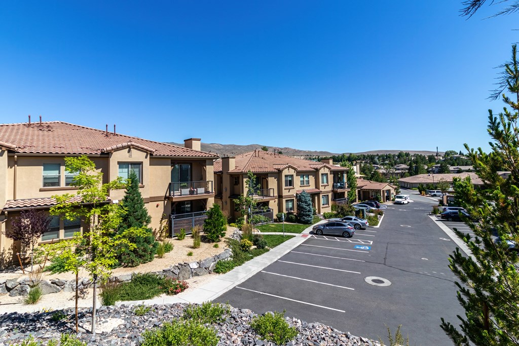 an empty parking lot in front of a row of houses