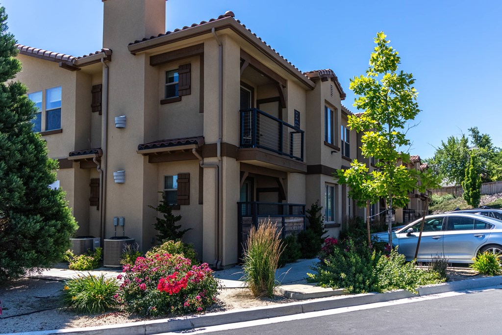 an apartment building with a car parked in front of it
