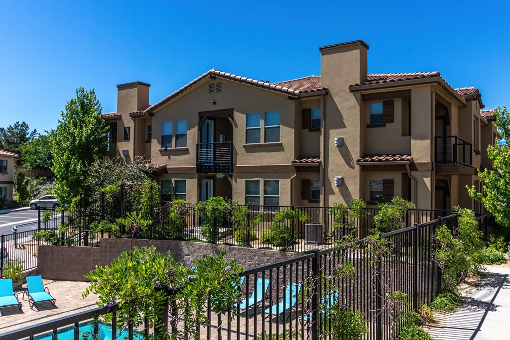 an apartment building with a swimming pool in front of it
