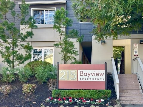 The Bayview Apartments sign is in front of a building.