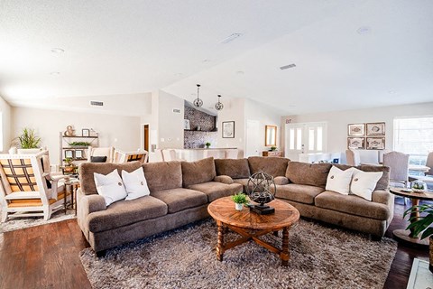 Clubhouse near kitchen with large couch  l Tyler Texas Apartments For Rent