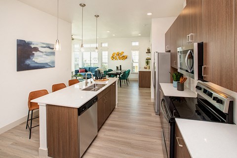 A modern kitchen with wooden cabinets and stainless steel appliances.