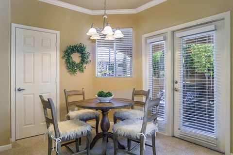 a dining room with a table and chairs