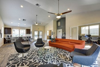 Apartments for Rent in Rocklin, CA - Community Clubhouse with Plush Seating, Tables, a Cooking Area, and TV. - Photo Gallery 2