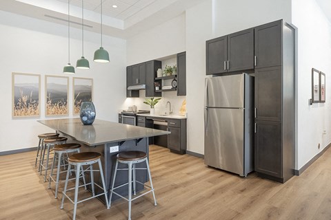 a kitchen with a stainless steel refrigerator and a table