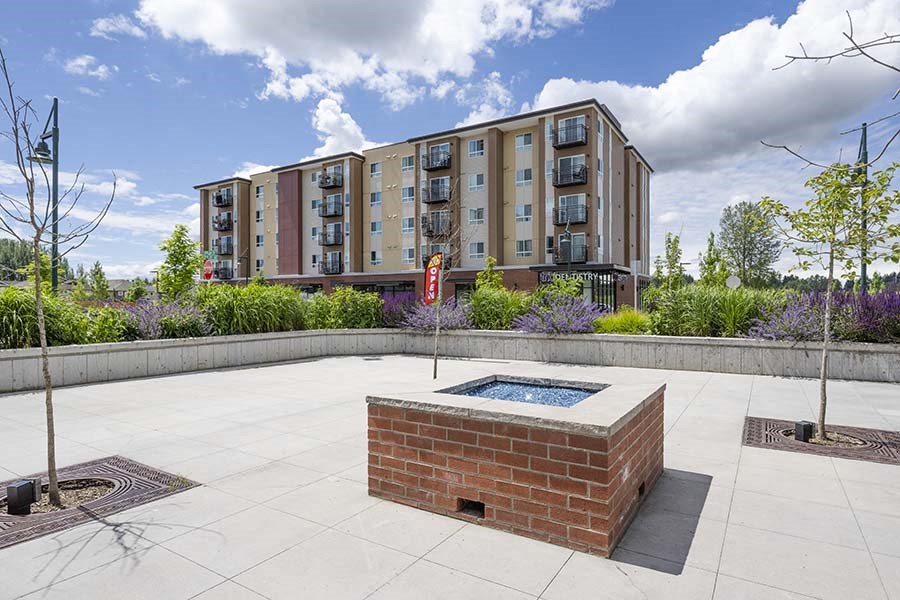 Outdoor Fire Pit With Bushes, Trees, And Flowers at FARM BY VINTAGE, MILL CREEK