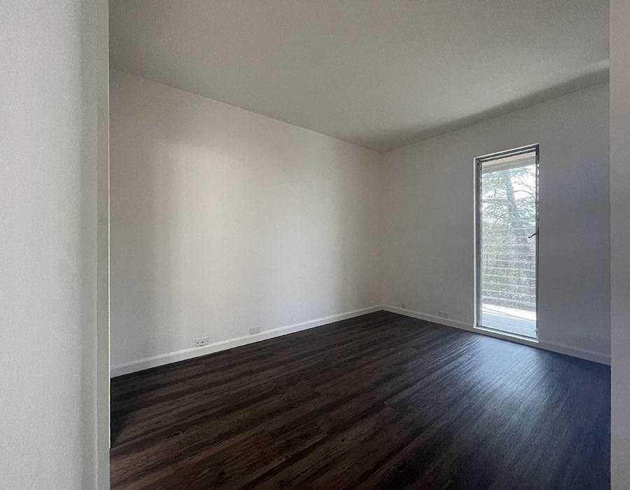 Apartments for Rent in North Oakland, CA - 225 Clifton - Bedroom with Wood-Plank Flooring and a Glass Door to the Outside