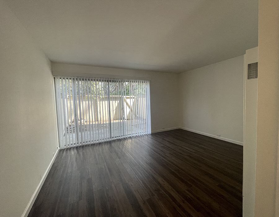 Living room with wood floors and large window