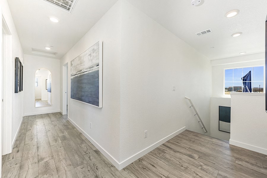 New Apartments in Roseville CA - Isles - Staircase Leading to Second-Story Hallway with Wood-Style Flooring
