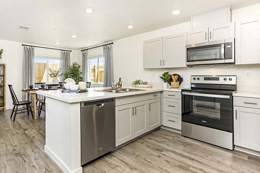 Brand New Homes For Rent in Roseville CA - Isles - White Kitchen with Wood-Style Flooring and Stainless-Steel Appliances
