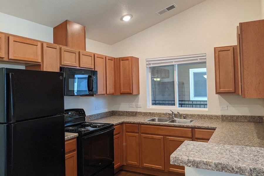2 BR Apartments in Reno, NV - Sky Vista Commons - Kitchen With Double Compartment Stainless Steel Sink, Laminate Countertops, and Window Above Sink