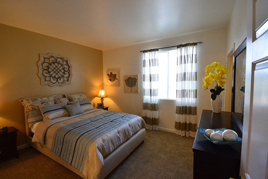 3 BR Apartments in Reno, NV - Sky Vista Commons - Bedroom with Large Window, Plush Carpet, Two-toned Walls, a Bed, Nightstand, and Dresser