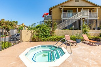 hot tub with lounge chairs by buildings - Photo Gallery 2