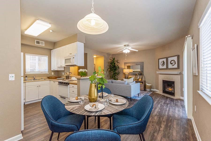 El Dorado Hills Apartments - Sterling Ranch - Dining Area with Wood Laminate Flooring, 4-Seater Dining Set, and Access to Kitchen and Living Room