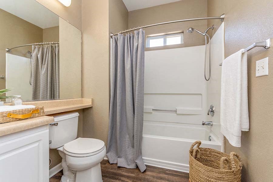 Apartments for Rent in El Dorado Hill - Sterling Ranch - Bathroom with Bathtub, Laundry Basket, and Large Vanity Mirror