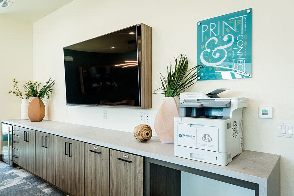 Office area with printer and TV