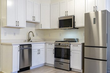 Kitchen with wood floors and stainless steel appliances - Photo Gallery 6