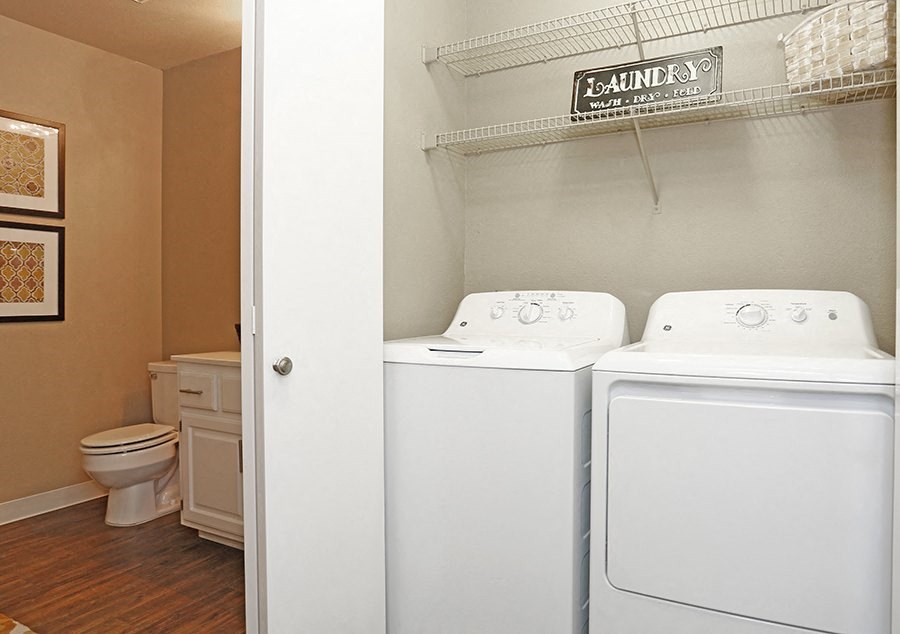 Washer and dryer next to bathroom