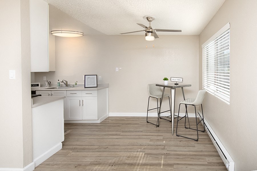 Kitchen with white cabinets near dining area