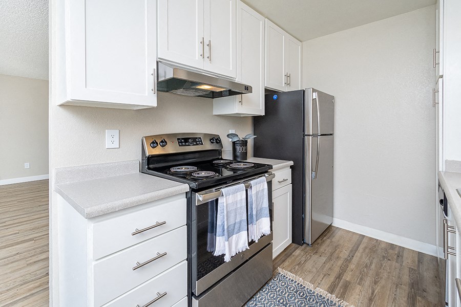 Rohnert Park Apartments- The Lenox- Stainless-Steel Appliances, Wood-Style Floors, White Cabinets, and Quartz Countertops