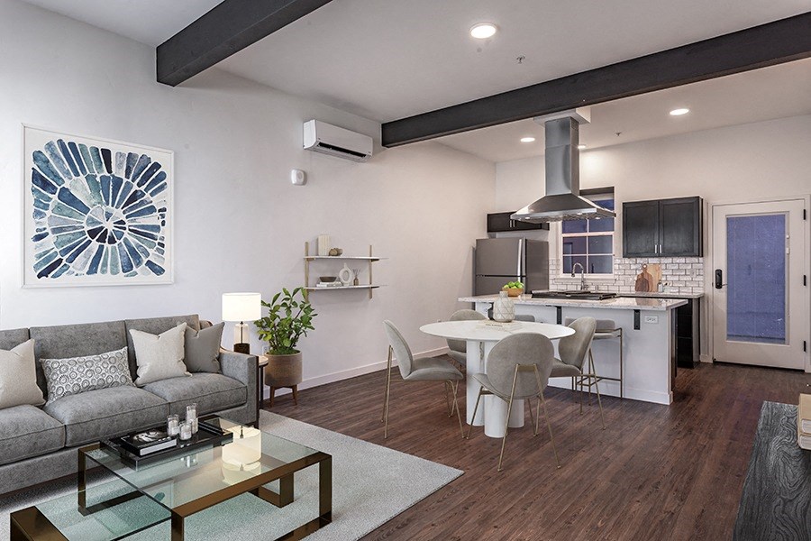 a living room and kitchen area with white walls and hardwood floors a living room and kitchen area with white walls and hardwood floors at THE ANGELINO, Sacramento, CA