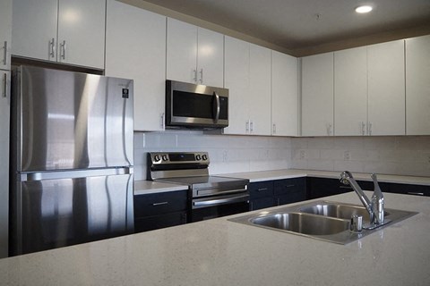 a kitchen with stainless steel appliances and white cabinets