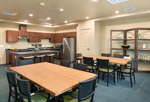 a dining room and kitchen with a table and chairs