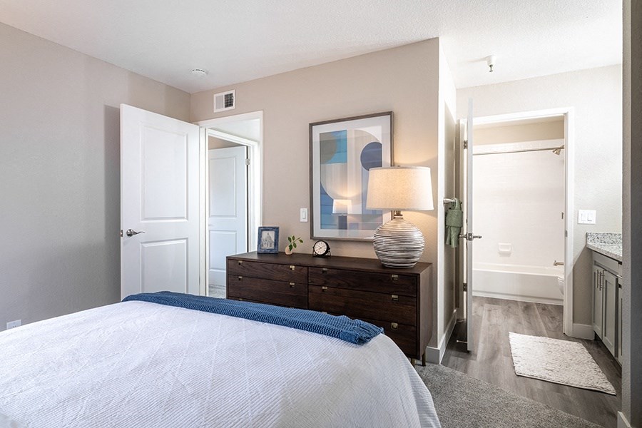 bedroom with bathroom and closet