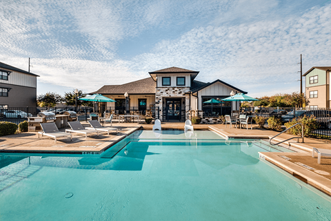 Pool with lounge chairs Blanco River Lodge Apartments for rent in 78666
