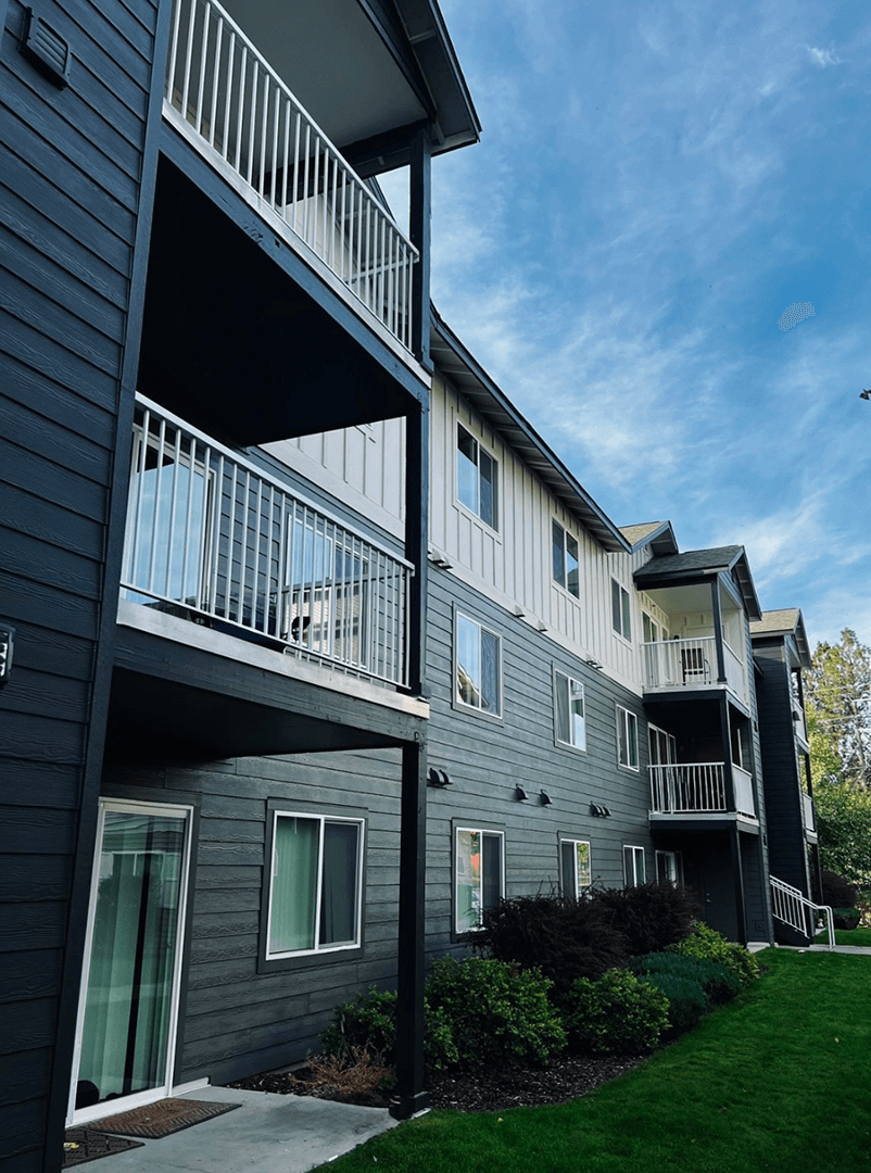 Apartment building with balconies and greenery Apartment building with balconies and greenery in front at Falls Creek Apartments in Couer d'Alene, 83815