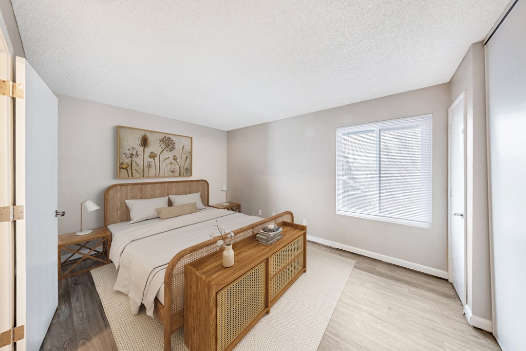 a bedroom with a large bed and a large window